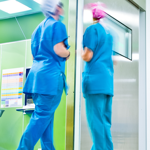 Three nurses in a hospital corridor